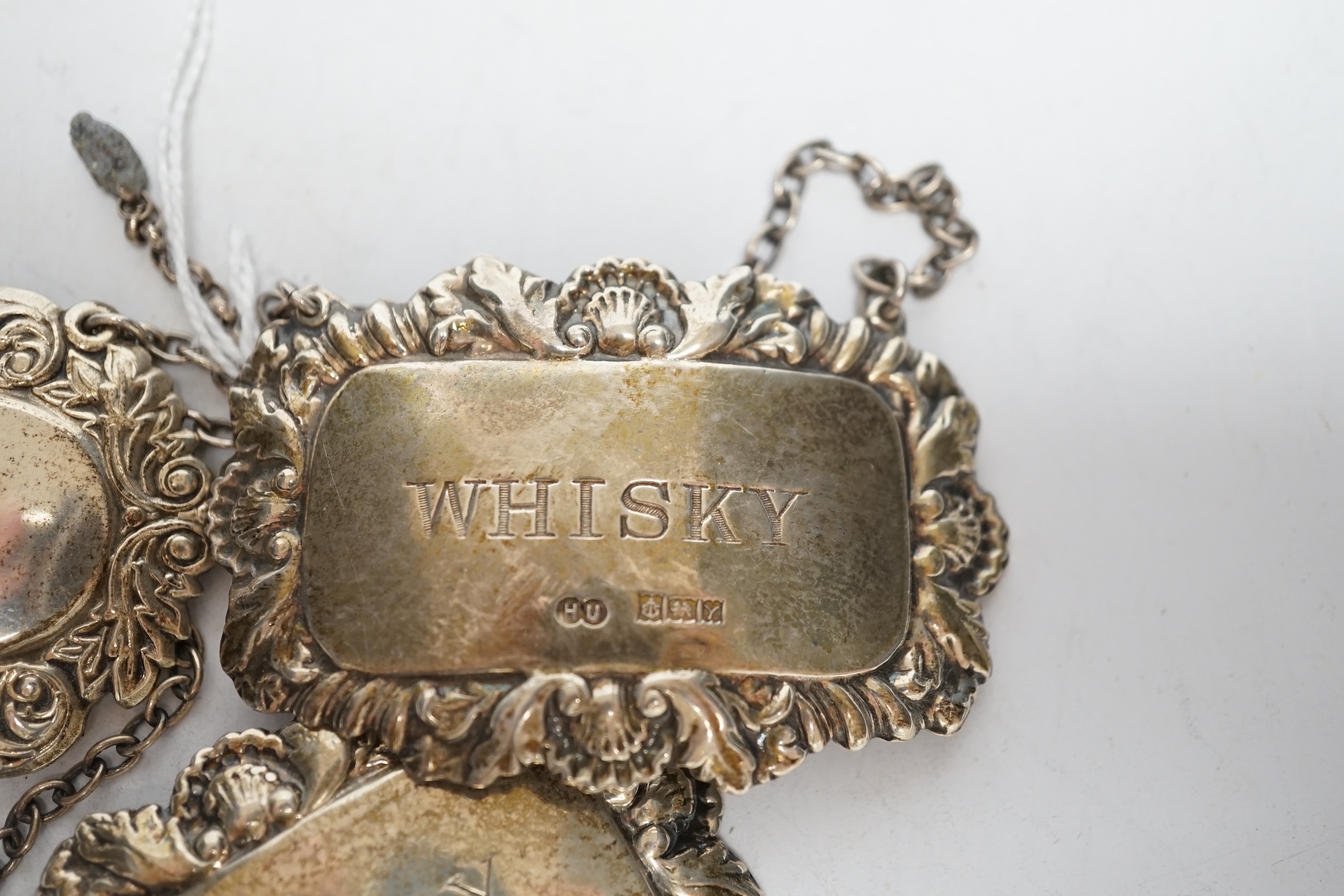 Three assorted modern silver wine labels.